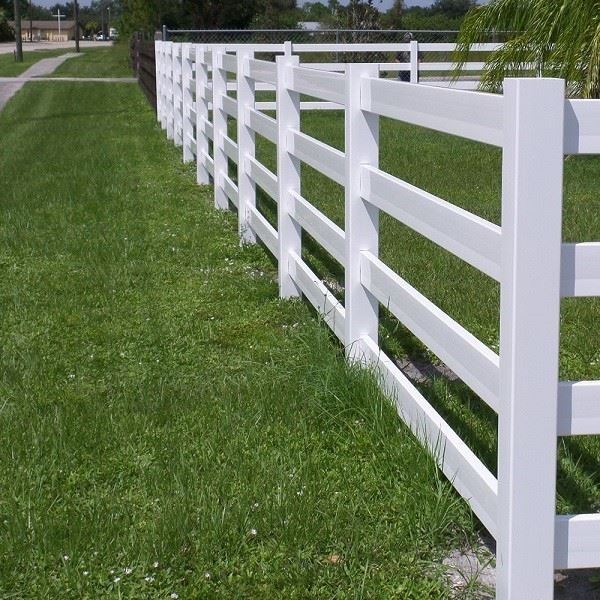 4 rail PVC fence in pasture White PVC 4 rail vinyl fence spanning across green pasture demonstrating weatherproof and UV stable performance in outdoor conditions