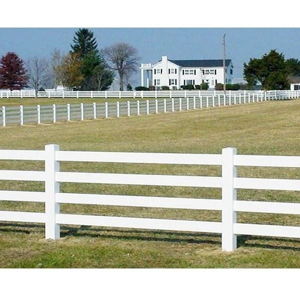 4 rail PVC split rail fence White PVC 4 rail split rail fence installed on open grassland property boundary with four horizontal rails and evenly spaced posts